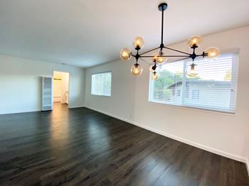 Stunning Living Room with Hardwood Floors, Modern Lighting, and Large Window at 2120 Valerga in Belmont, 94002